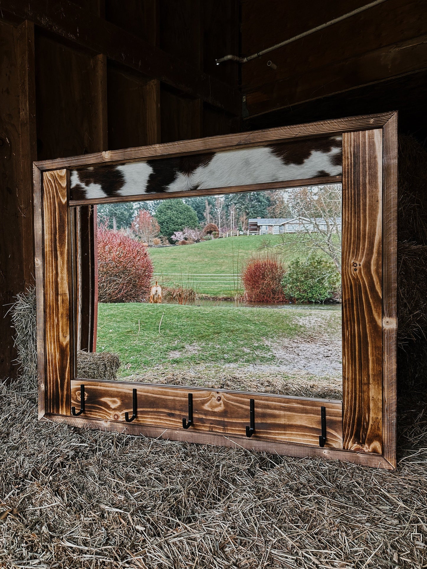 Cowhide framed mirror with hangers