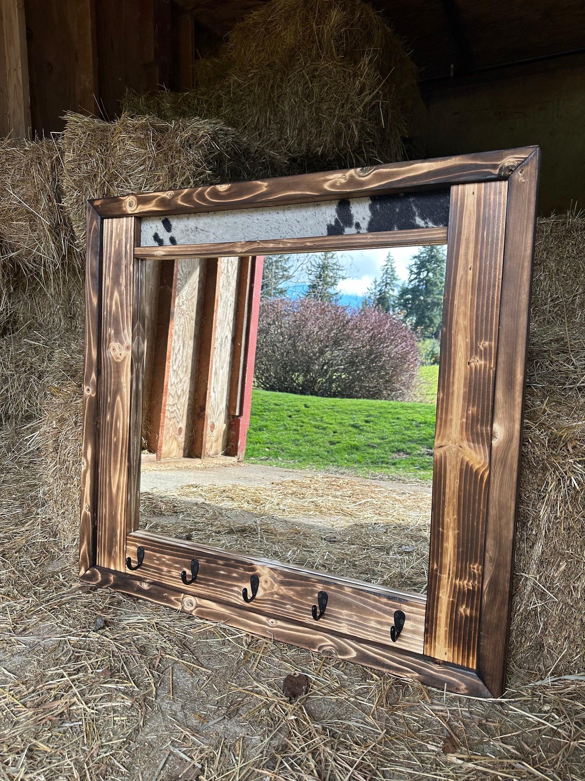 Cowhide framed mirror with hangers