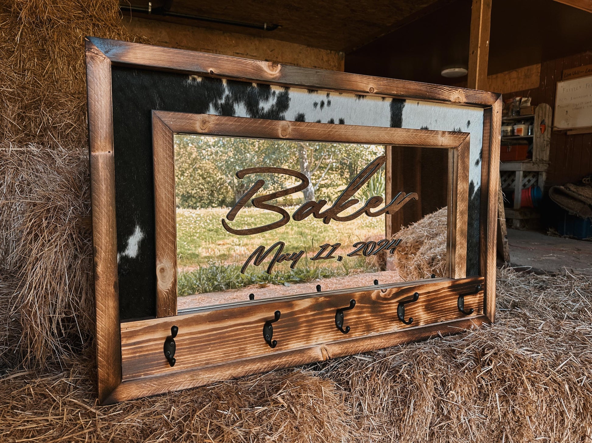 Cowhide framed mirror with hangers