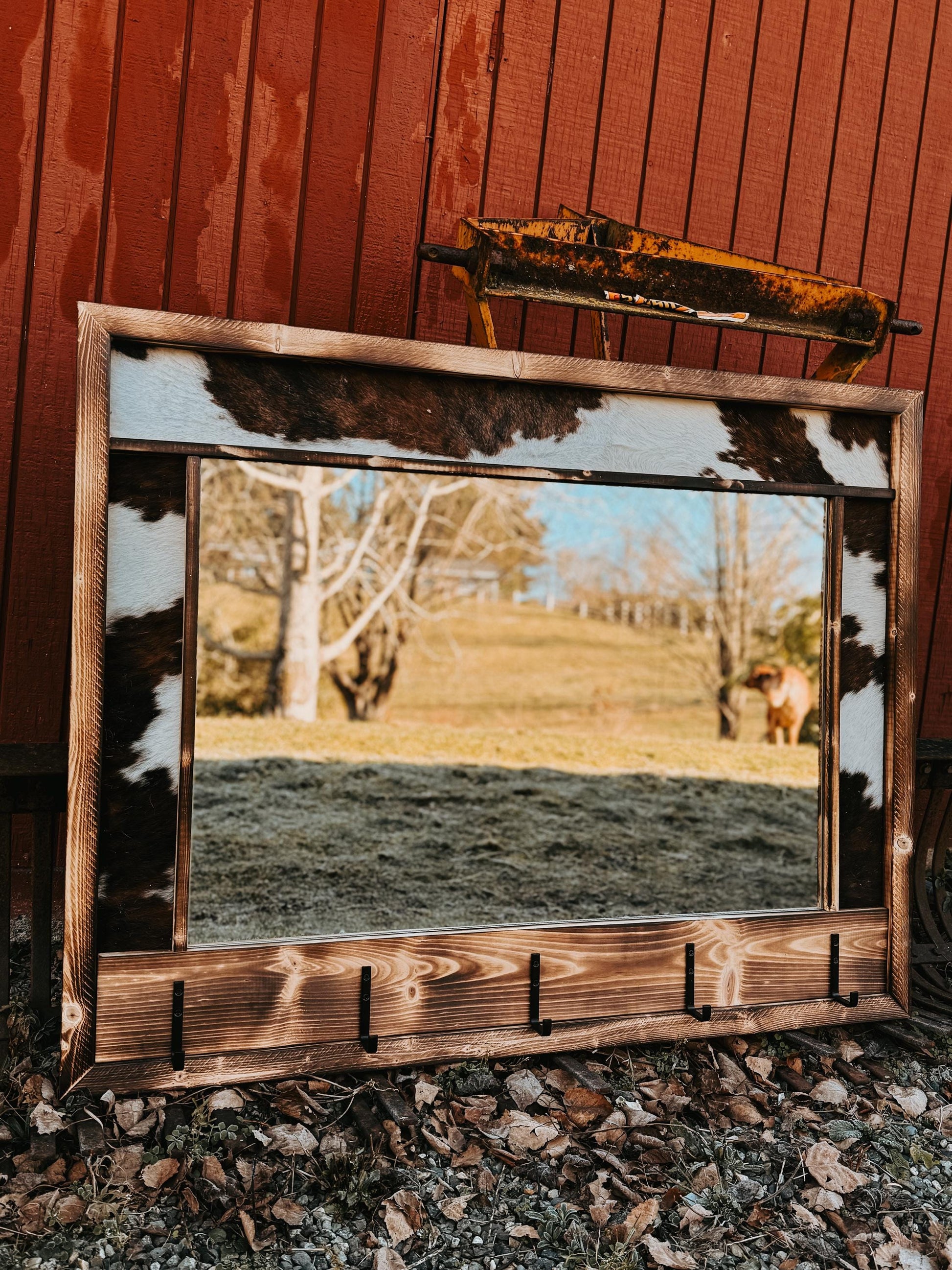 Cowhide framed mirror with hangers