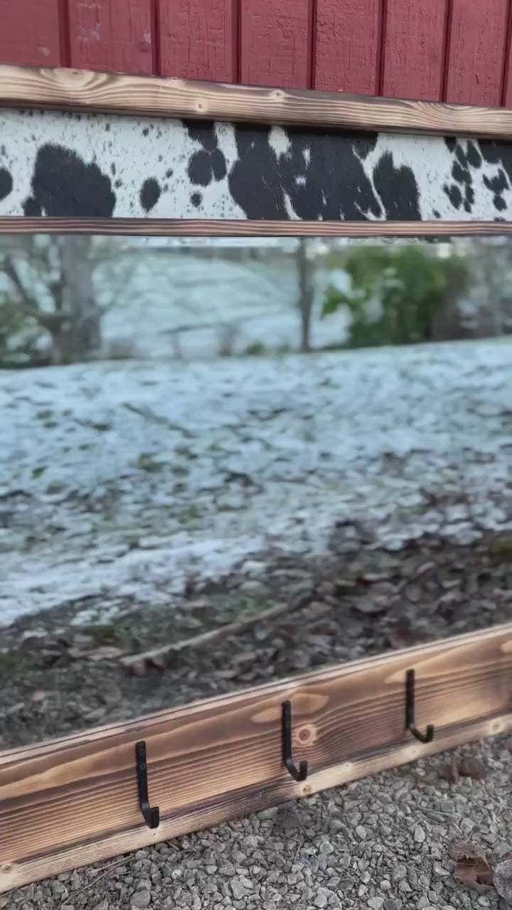 Cowhide framed mirror with hangers